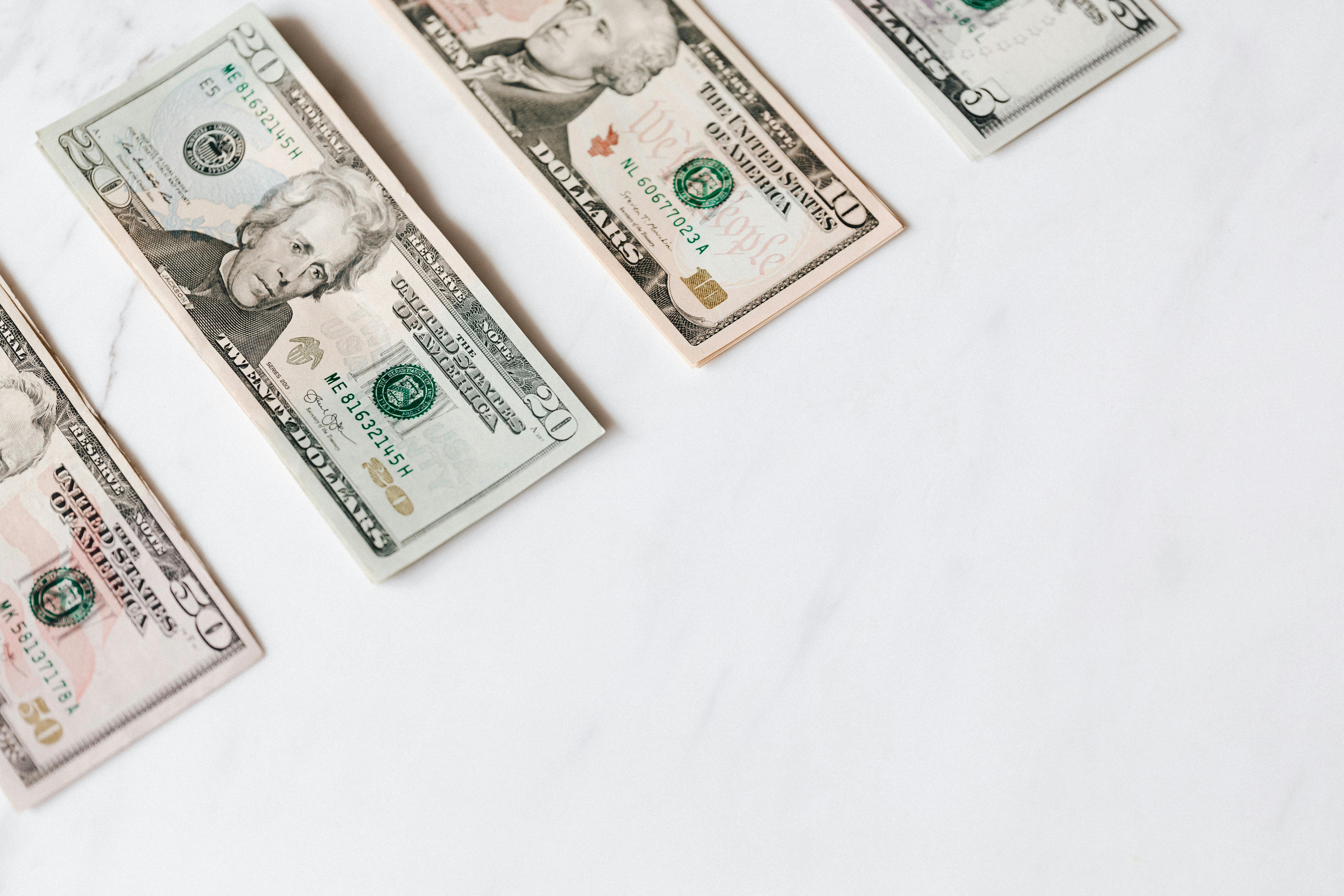 set of various dollar banknotes on white table