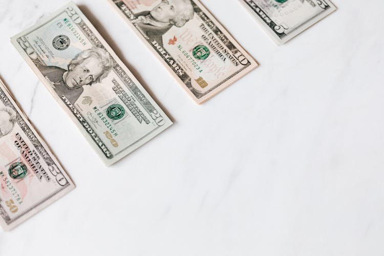 Set Of Various Dollar Banknotes On White Table