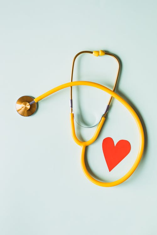 Free Medical stethoscope with red paper heart on white surface Stock Photo