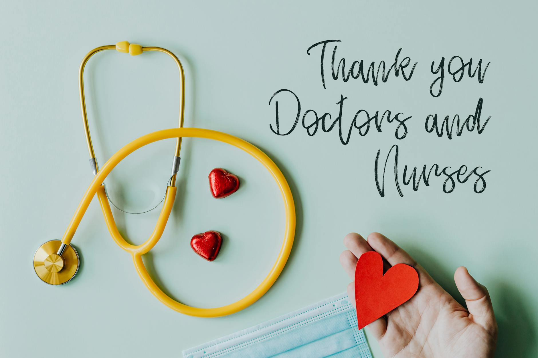 Yellow stethoscope and red hearts with text