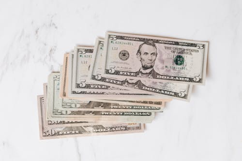 Stack of Dollar Bills on Marble Surface