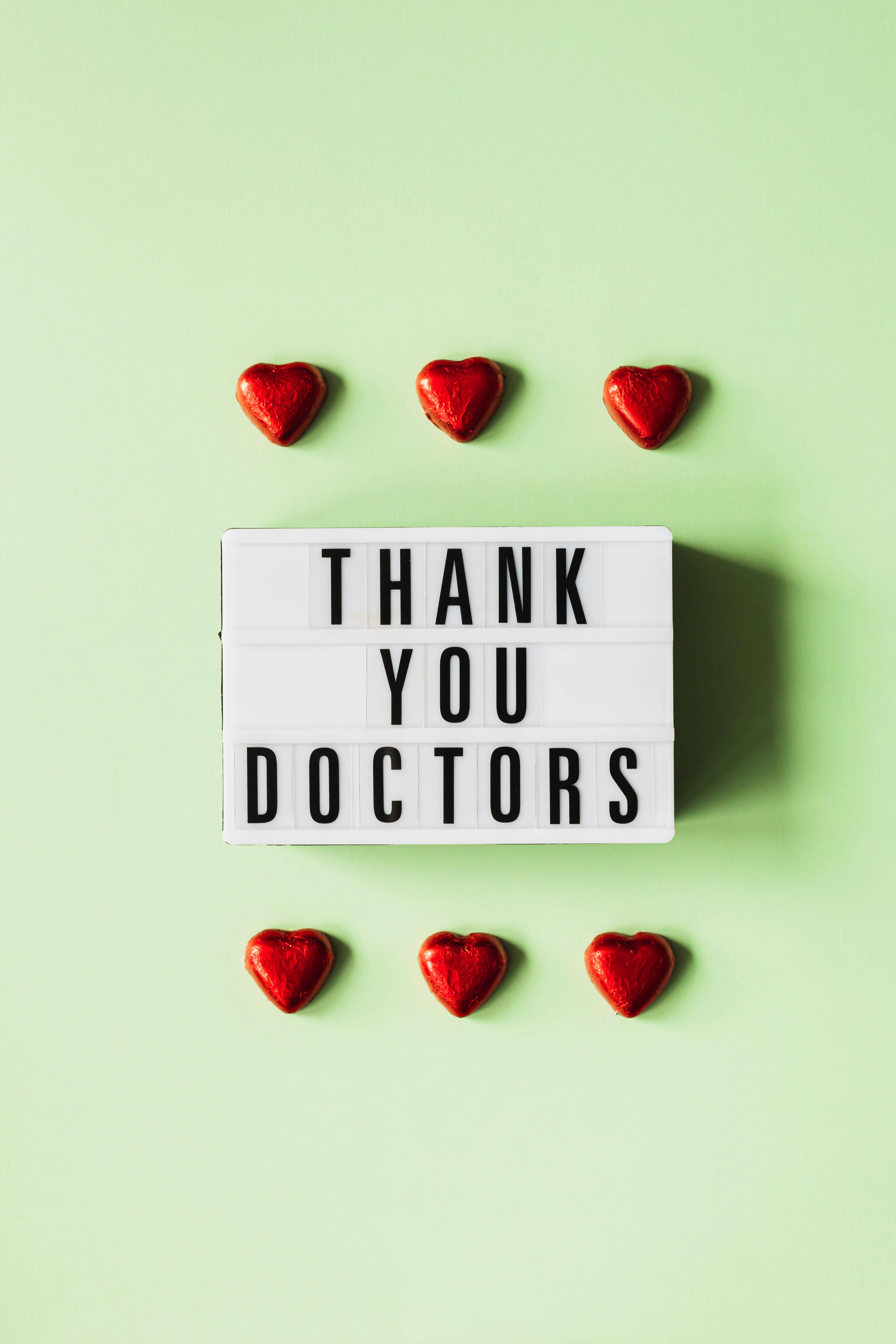 heart figurines and retro lightbox with inscription for doctors