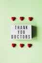 Heart figurines and retro lightbox with inscription for doctors