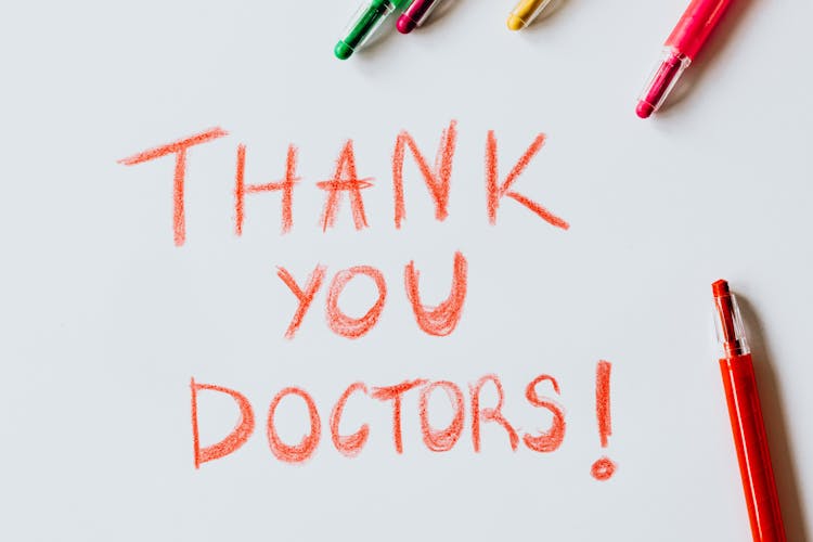 Thank You Doctors Written With Red Colored Pencil