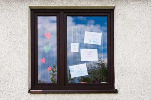 Free Handwritten notes and hearts on a window express gratitude to doctors. Stock Photo