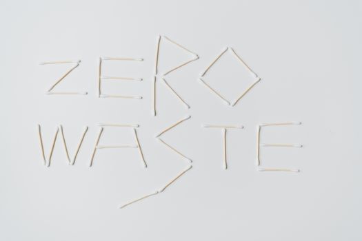 Creative layout of zero waste sign formed with cotton swabs on a white background.