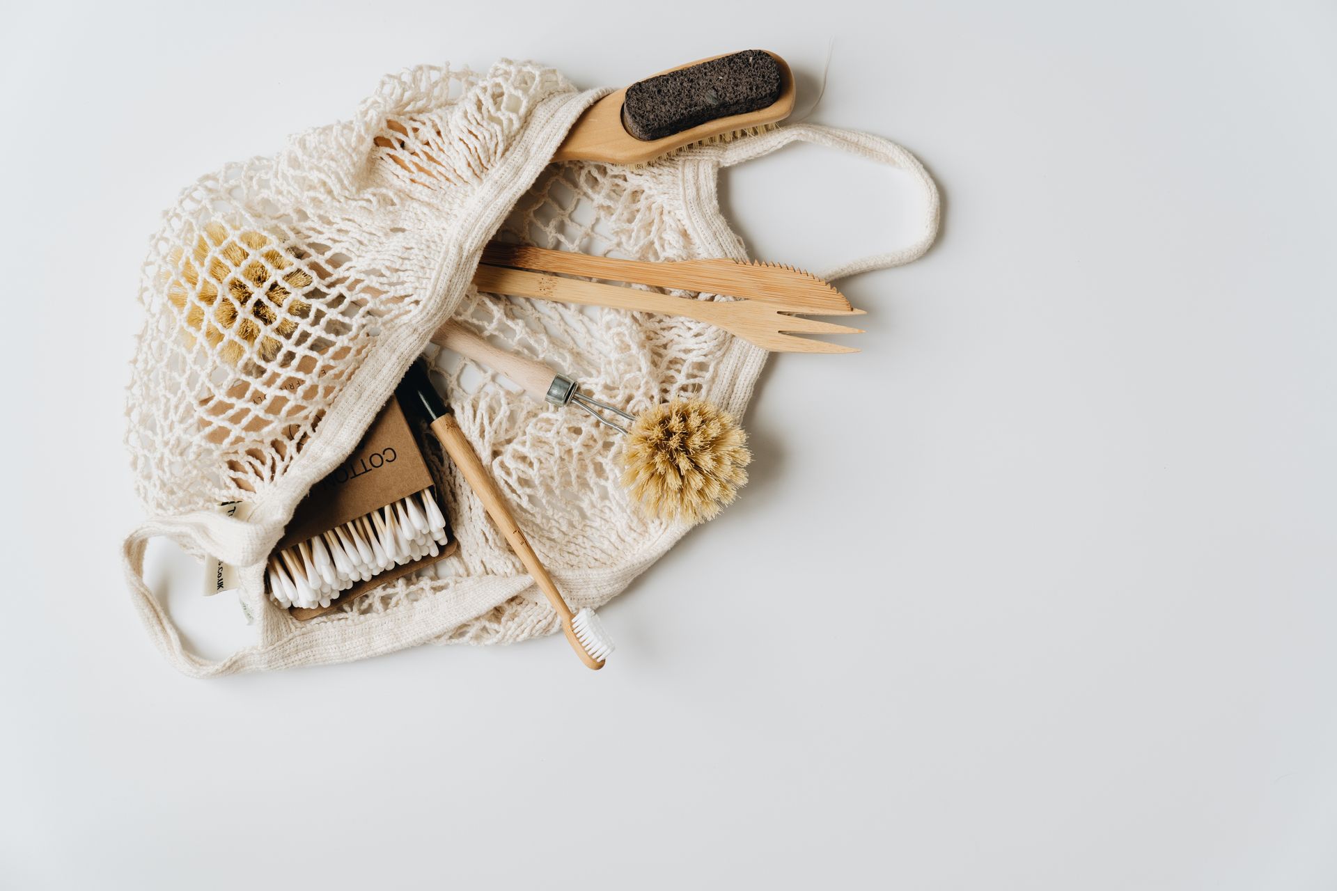 Minimalist flat lay of zero-waste personal care essentials featuring bamboo and natural materials.