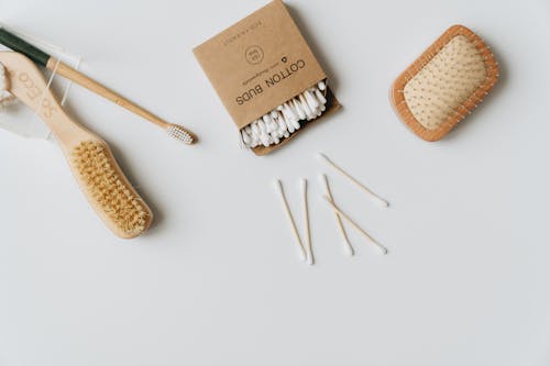 Cotton Buds and Hairbrushes on White Background