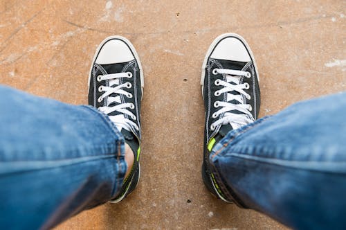 Free Person Wearing Black and White Converse All Star High Top Sneakers Stock Photo