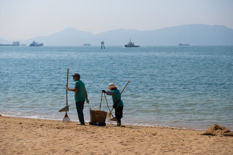 People Cleaning On The Beach 