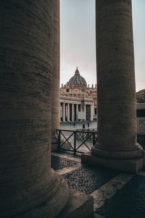 Free Weathered stone columns located near square with renaissance Cathedral of Saint Paul in Vatican Stock Photo