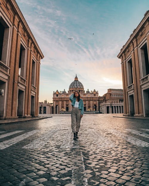 Full length of young female tourist standing against old historical Christian building  Cathedral of Saint Paul