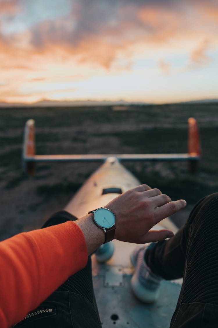 Man Checking Time On Wristwatch In Evening