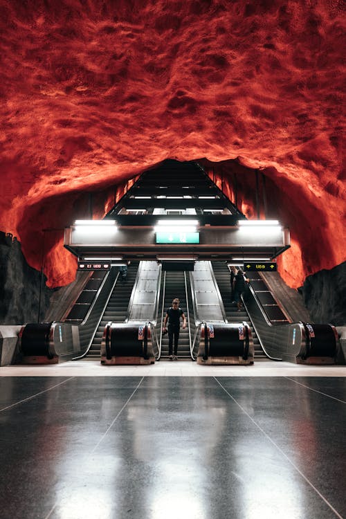 Man descending on escalator in modern underground