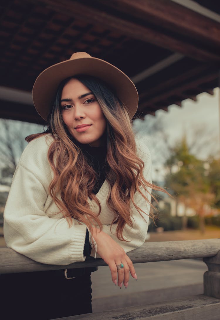 Elegant Ethnic Woman In Felt Hat On Porch