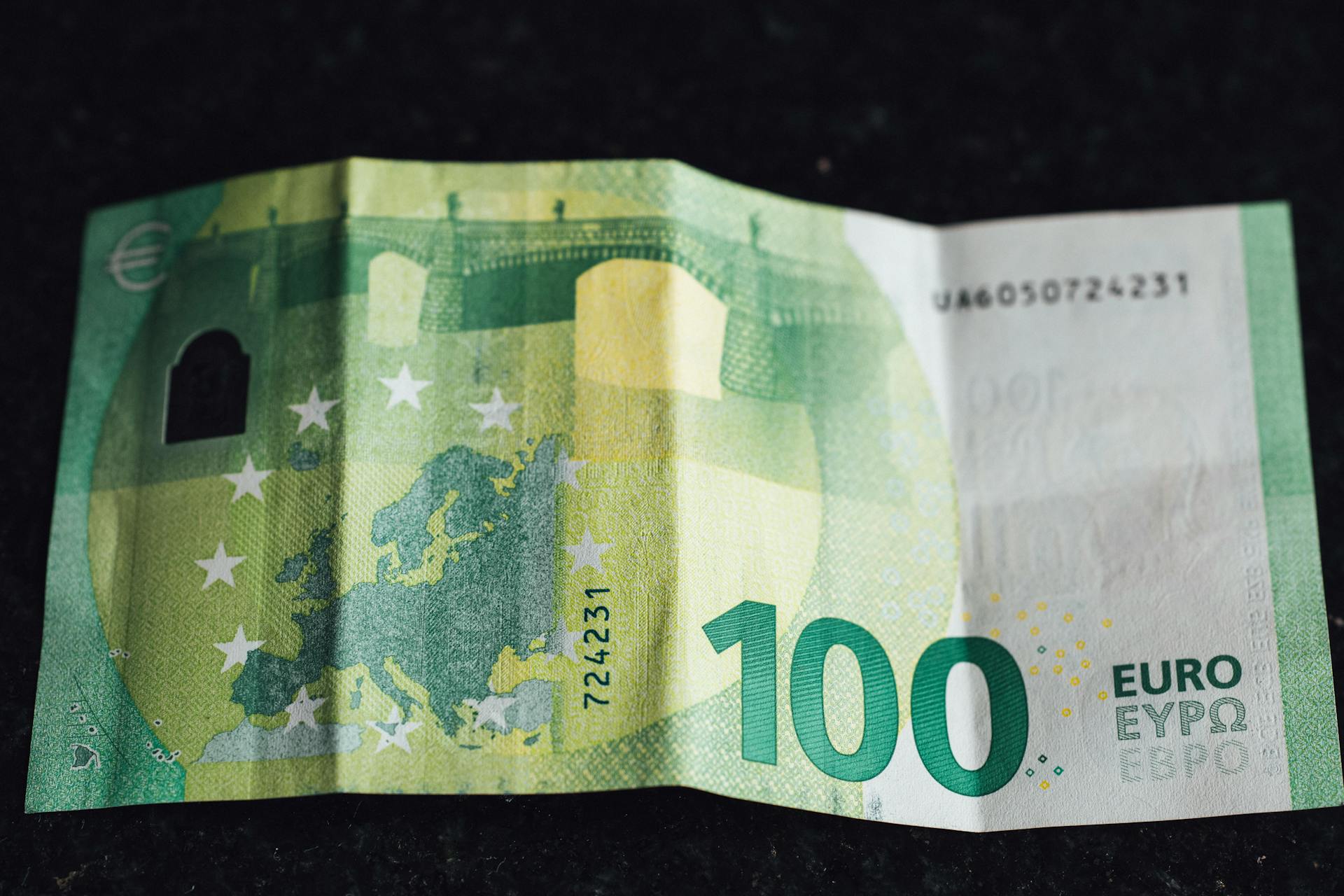 Close-up image of a 100 Euro banknote highlighting its design and details.