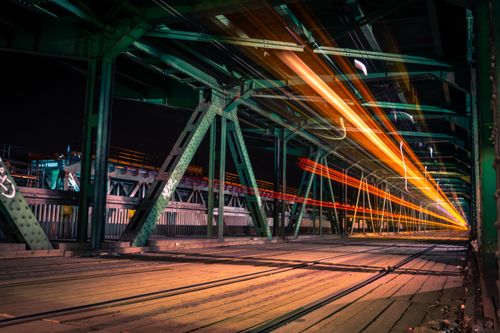 Free Dynamic night view of a bridge in Warsaw with vibrant light trails and steel structure. Stock Photo