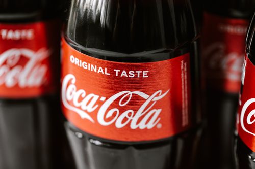 Free Set of glass bottles of refreshing cold coke with red sticker placed close to each other Stock Photo