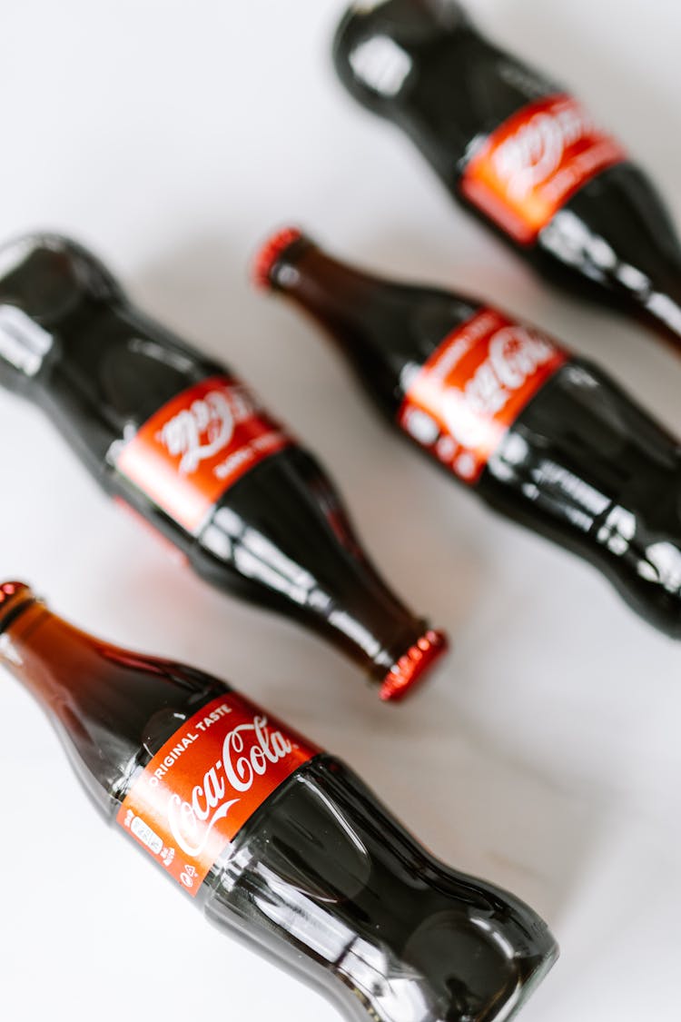 Bottles Of Nonalcoholic Beverage Placed On White Table