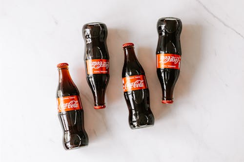 Free High angle composition of bottles of soft drink placed on white marble table Stock Photo