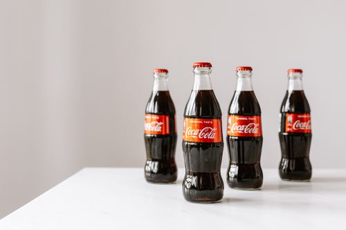 Free Set of bottles full of fresh nonalcoholic beverage placed on white table Stock Photo