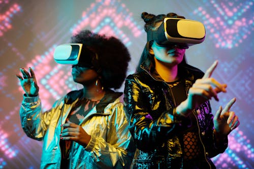 Two Young Women Wearing VR Goggles