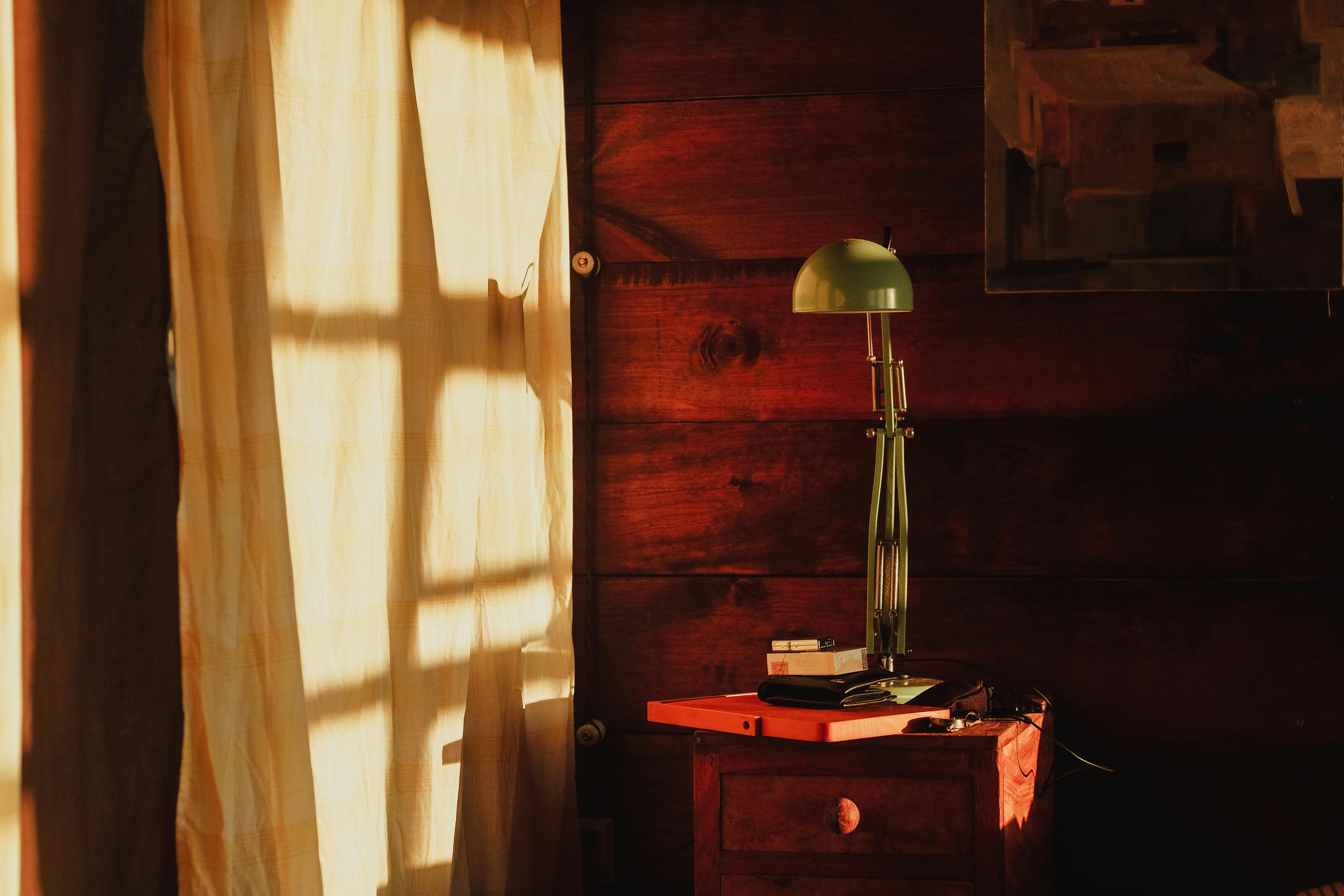 Warm sunlight fills a vintage-style room with a minimal setup, enhancing the ambiance.
