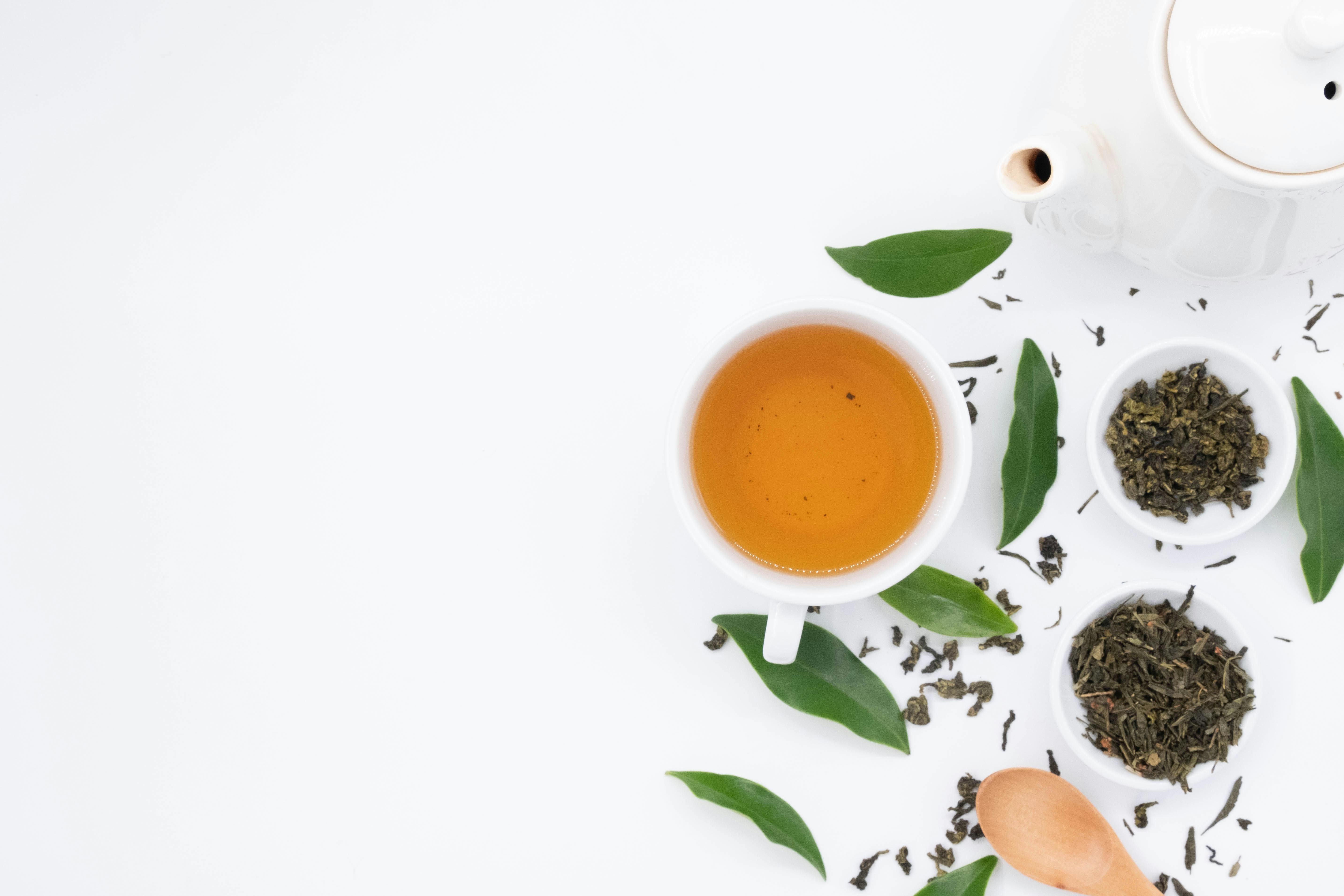 Green tea with leaves on white background · Free Stock Photo
