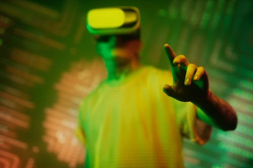 Free Man in Yellow Crew Neck Shirt Wearing White and Black Vr Goggles Stock Photo