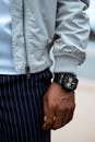 Crop man in stylish wear and wristwatch outdoors