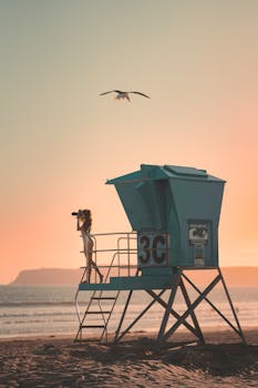 Capture of a lifeguard station and a person at sunset on the beach.