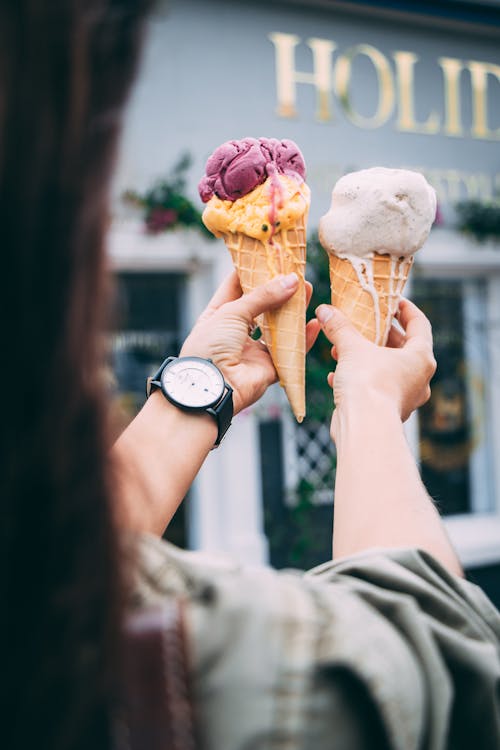 Person Holding Ice Cream Cones