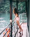 Woman in Black and White Stripe Bikini Standing on the Balcony