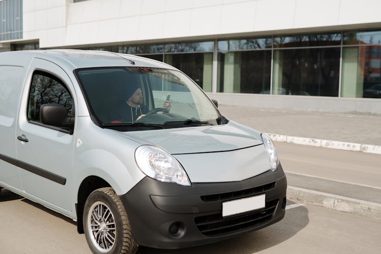 Man Driving A Silver Renault Kangoo Van