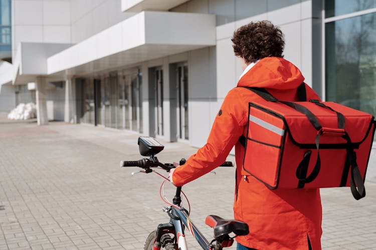 Delivery Man In Orange Jacket