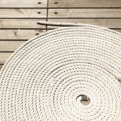 Coiled rope on a wooden deck — photo by Arın Turkay on Pexels