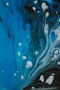 Top view of white droplets on surface of blue painting as abstract background