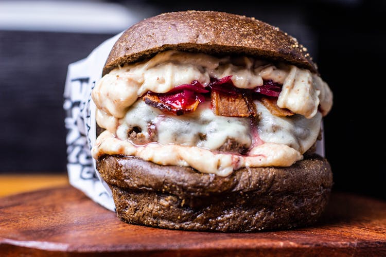 Delicious Burger With Meat Patty And Cheese On Table