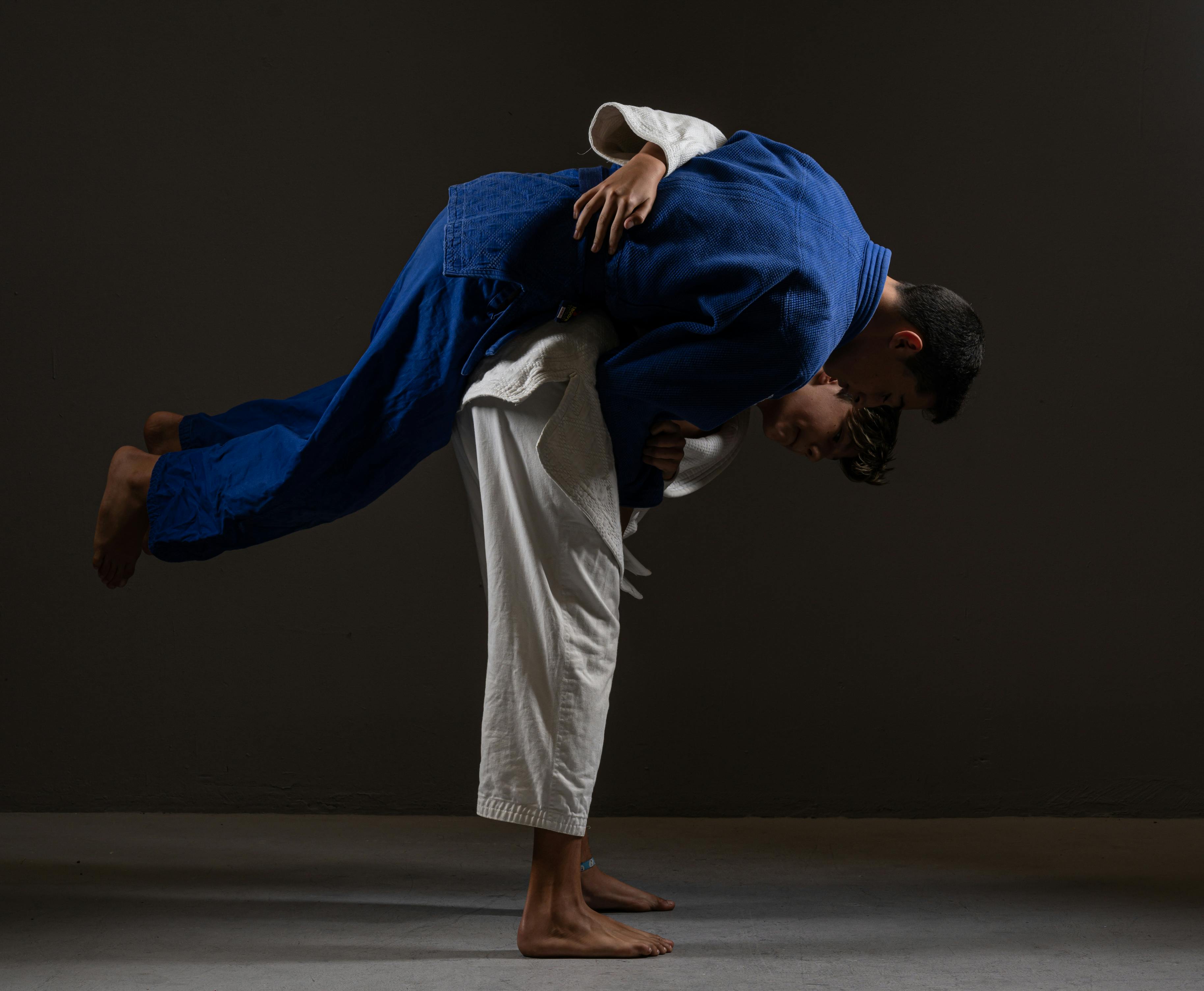 Young ethnic judoists performing Nage waza technique · Free Stock Photo