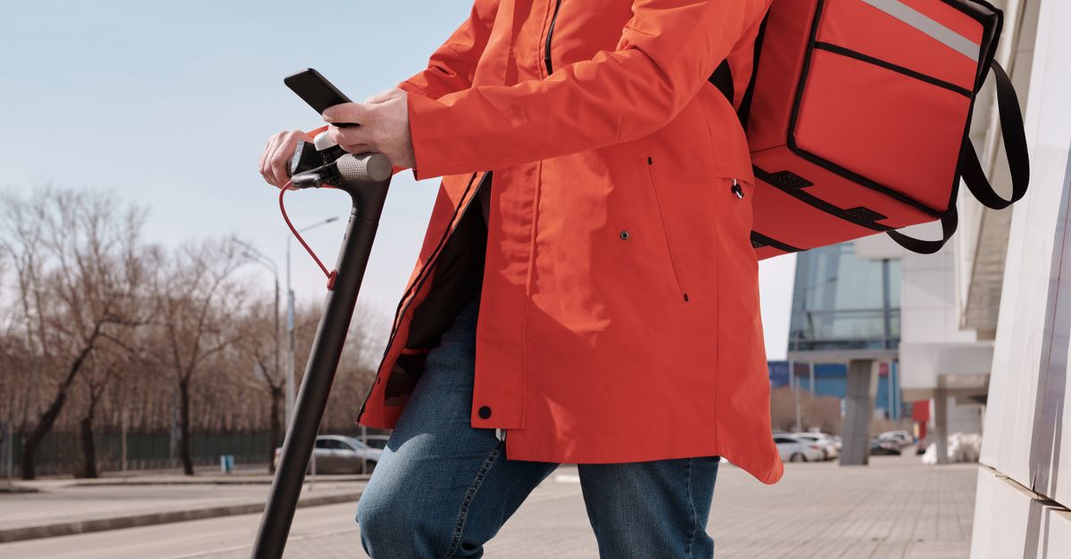 Delivery Man Using Remote Delivery Man Checking his Smartphone · Free Stock Photo
