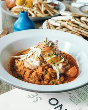 A mouthwatering seafood risotto garnished with herbs, perfect for a gourmet dining experience.