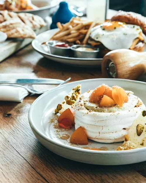 Free Delicious gourmet dessert with brunch plates on a rustic wooden table, perfect for food photography enthusiasts. Stock Photo