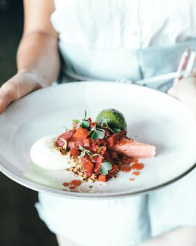 Delicious gourmet dessert with fresh fruit and sauce on a plate.