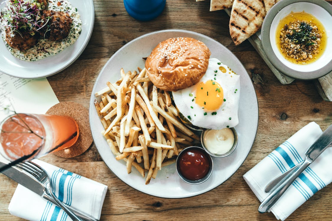 Free Delicious Burger with Fried Egg and Fries Stock Photo