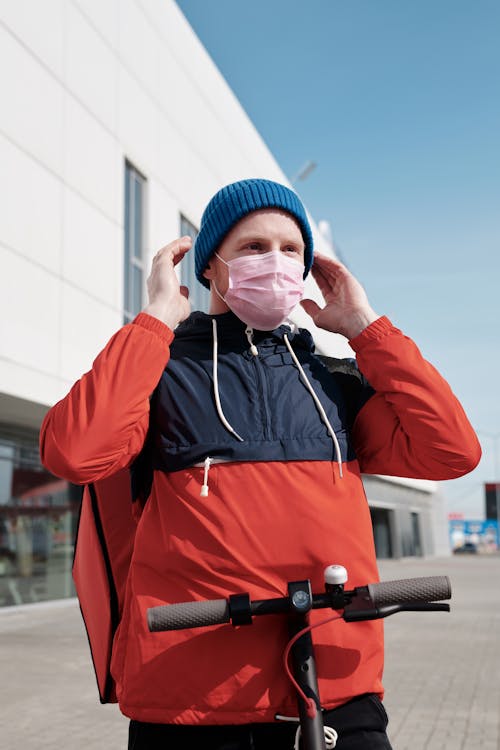 Free Delivery Man Wearing a Face Mask Stock Photo