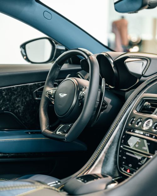 Free Close-up of a luxury car interior showing the steering wheel and dashboard design features. Stock Photo