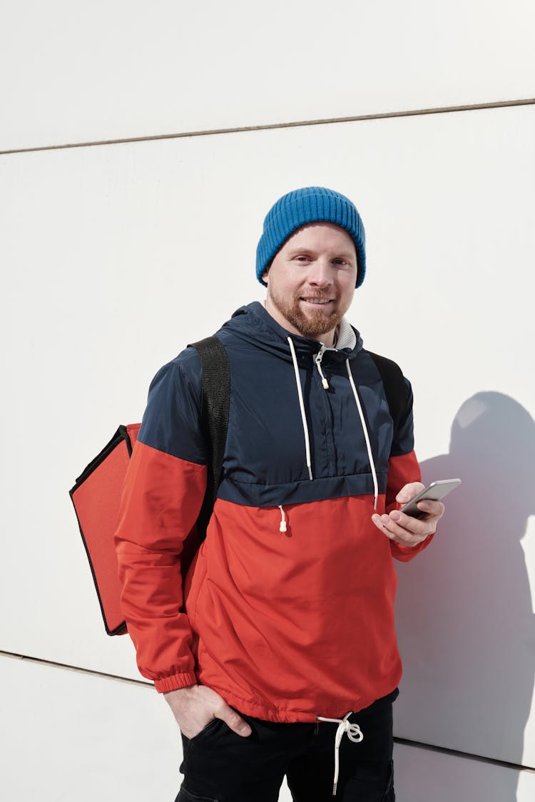 Man Wearing Jacket Carrying A Thermal Bag