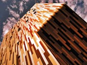 低角度镜头捕捉了现代化、色彩缤纷的建筑立面与戏剧性天空的映衬