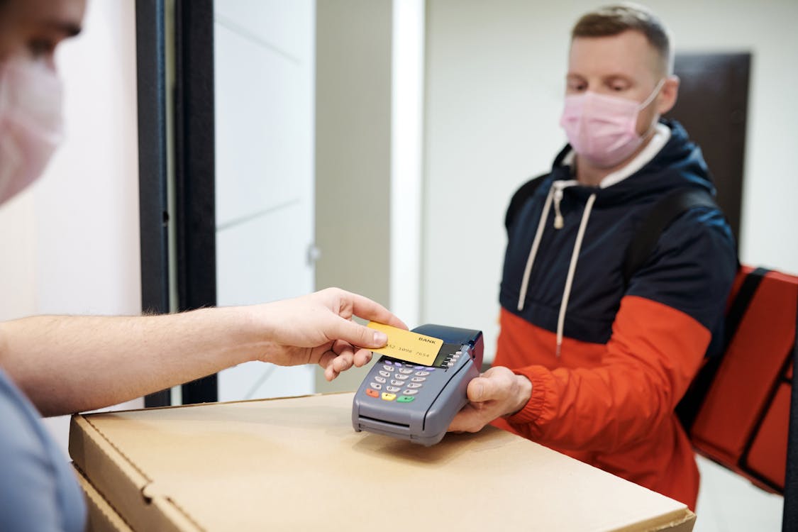 Free Person Paying for Food Delivery with a Credit Card Stock Photo