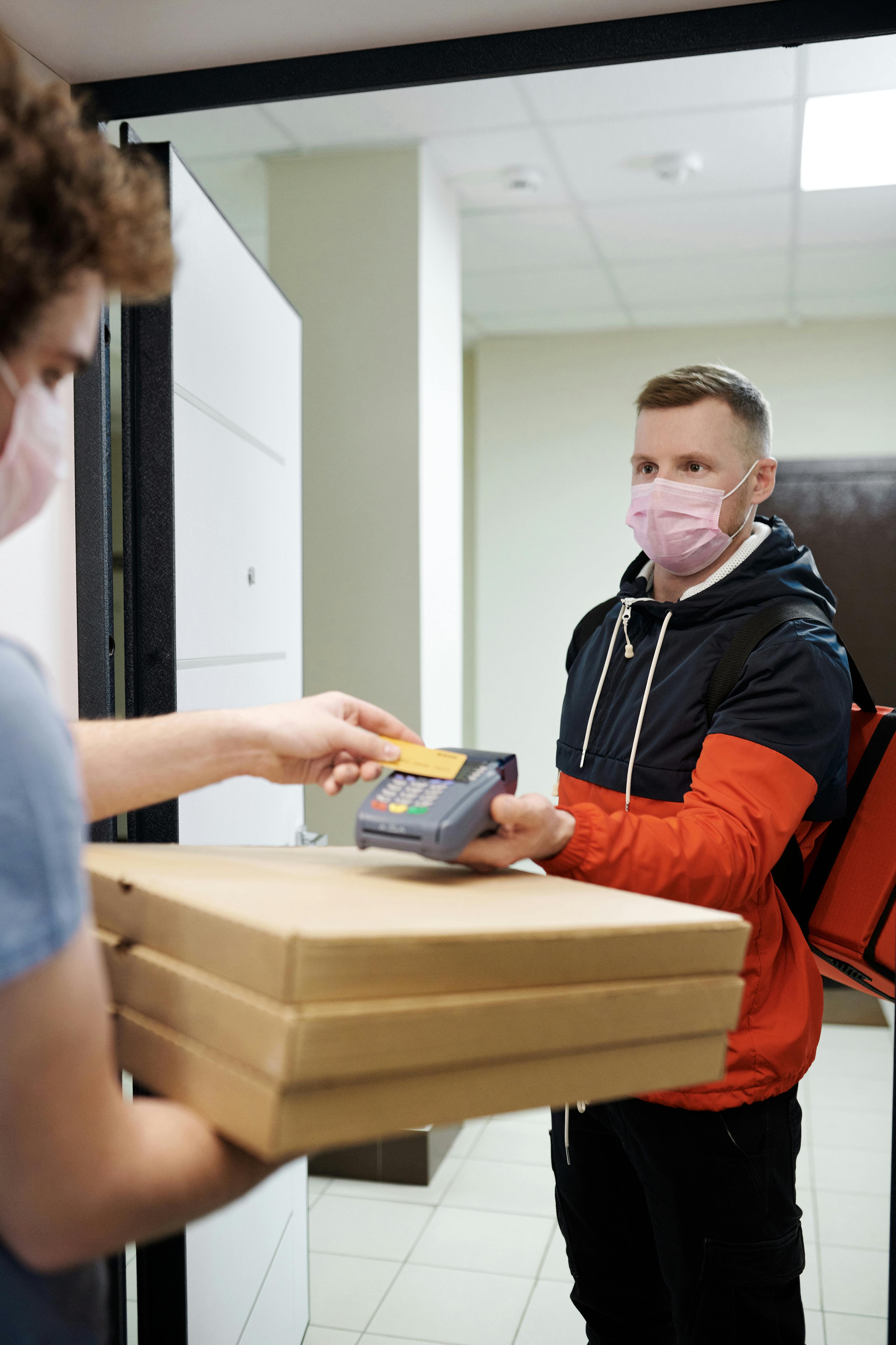 person paying for food delivery with a credit card